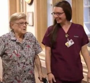 Caregiver walking with senior resident