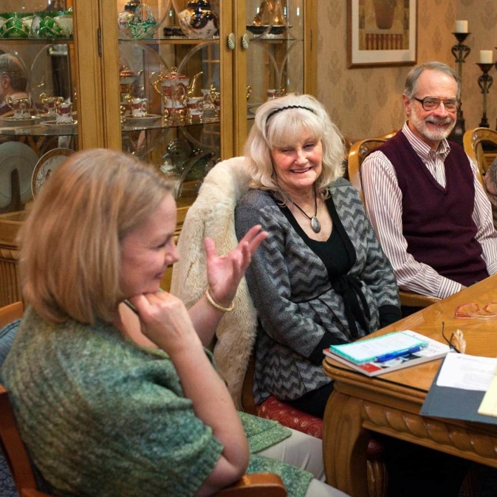 Members of the caregiver support group meeting around a conference table.