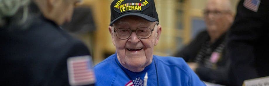 WWII Veteran receiving a flag on Veterans Day