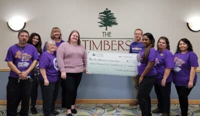 Timbers Staff holding check