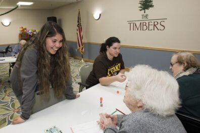 Andrea Villa and Kaitlyn Klein from University of St. Francis Recreation and Sport Management program spend time with Timbers of Shorewood residents