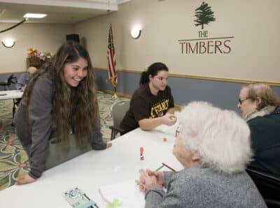 Andrea Villa and Kaitlyn Klein from University of St. Francis Recreation and Sport Management program spend time with Timbers of Shorewood residents