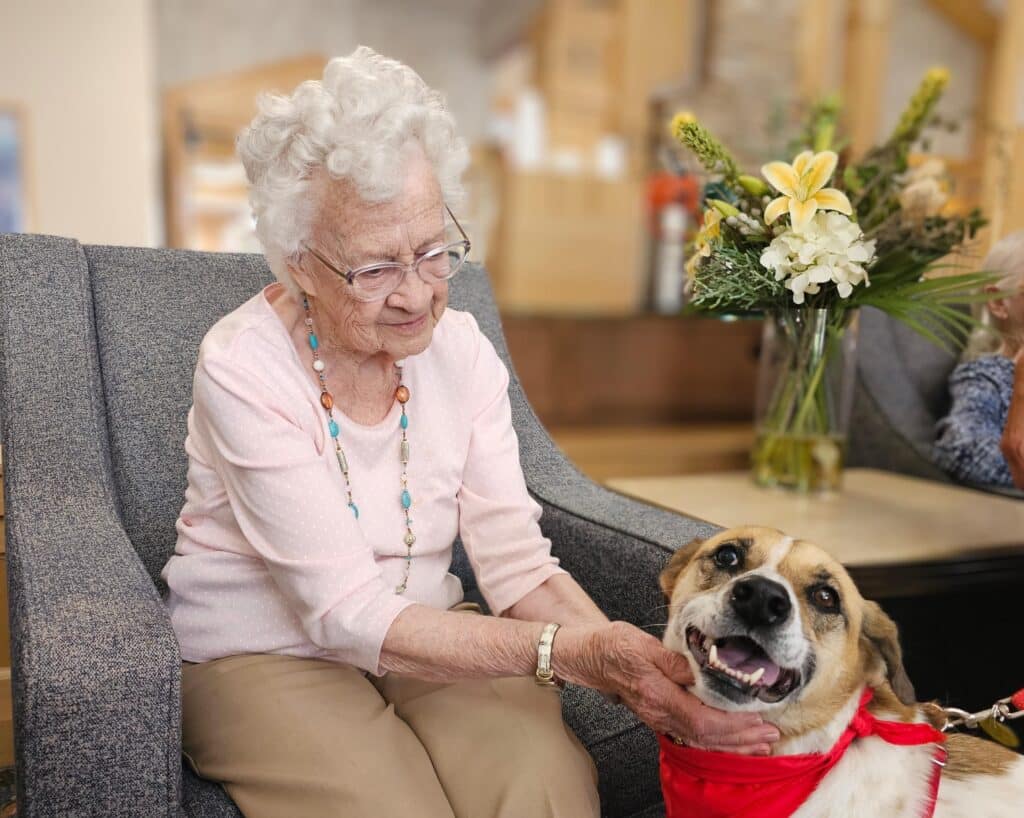 Maya the therapy dog and a senior from the Timbers of Shorewood
