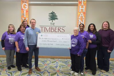 Team Timbers with check for $16,000 to the Alzheimer's Association on #GivingTuesday