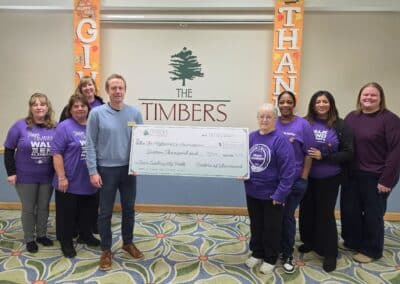 Team Timbers with check for $16,000 to the Alzheimer's Association on #GivingTuesday