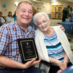 Joel Martis, 2026 volunteer of the year award winner with his mother at The Timbers of Shorewood